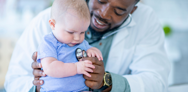 Imagen de doctor sosteniendo un bebé.